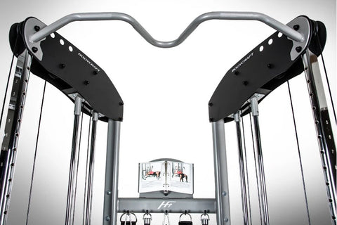 Silver and black dual cable machine functional trainer with weight stacks, hanging handles, and digital display on white back