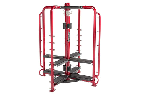 Red and black multi-station fitness cage with leg press, chest press, and lat pulldown attachments on white background