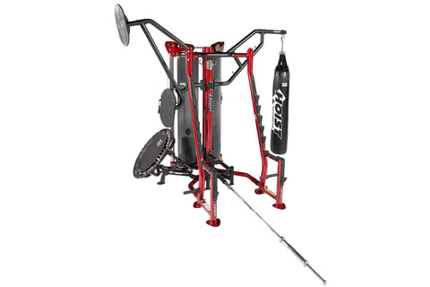 Red and black Hoist MCS-8005 multi-station gym equipment with boxing heavy bag attachment on left arm, displayed on white bac