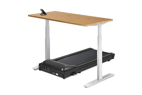 White desktop treadmill desk with black treadmill base, white support columns, and control panel on gray background