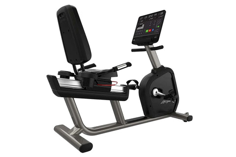 Black and silver recumbent stationary exercise bike with digital display console, padded seat and backrest, on white backgrou
