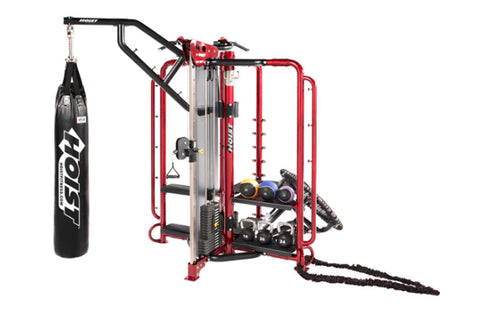 Red and black multi-functional home gym cage with pull-up bar, adjustable arm machine, heavy bag attachment, and tire wheel o
