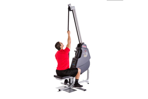 Man in red shirt using gray and black rope training machine with pulley system on white background