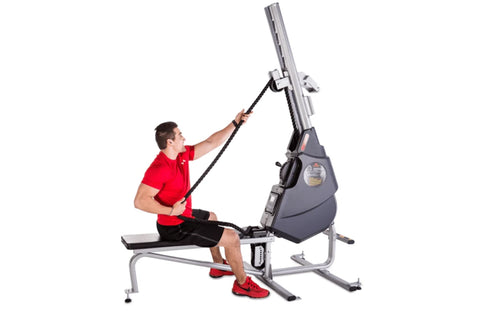 Man in red shirt using gray and black Marpo VMX 360 rope trainer machine with adjustable arm on white background