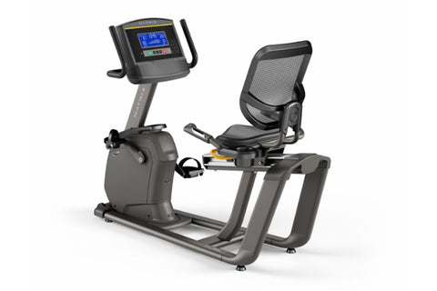 Matrix R30 recumbent exercise bike with gray frame, digital display console, black mesh backrest, and foot pedals on white ba