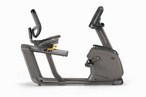 Matrix R30 recumbent exercise bike with gray frame, digital display console, black mesh backrest, and foot pedals on white ba