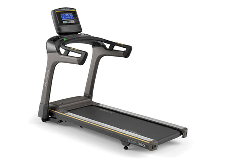 Matrix T50 treadmill with black running deck, gray frame, dual handlebar grips, and digital display console on white backgrou