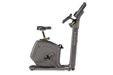 Matrix U30 upright exercise bike with black frame, digital console display, handlebars, and padded seat on white background