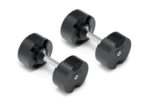 Pair of black adjustable dumbbells with chrome handles and numbered weight plates, flat lay on white background
