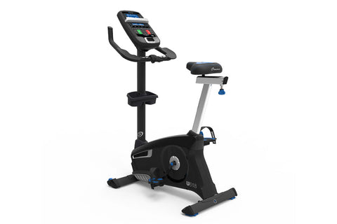 Nautilus U618 upright exercise bike with black frame, digital console, curved handlebar, and blue accent pedals on white back