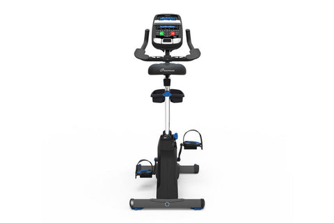 Nautilus U618 upright exercise bike with black frame, digital console, curved handlebar, and blue accent pedals on white back