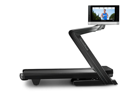 Black NordicTrack 2450 commercial treadmill with digital touchscreen displaying running workout on white background