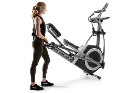 NordicTrack 9.9 Commercial Elliptical with black and silver frame, dual handles, digital console, and pedal platform on white