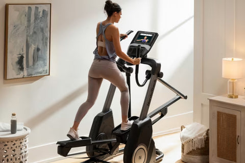 Black NordicTrack FS10i elliptical machine with digital console and moving handles, displayed on white background