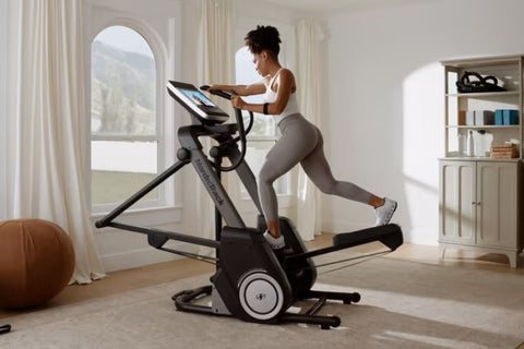 NordicTrack FS14i elliptical with gray frame, black pedals and handlebars, digital display console, and cable attachment on w