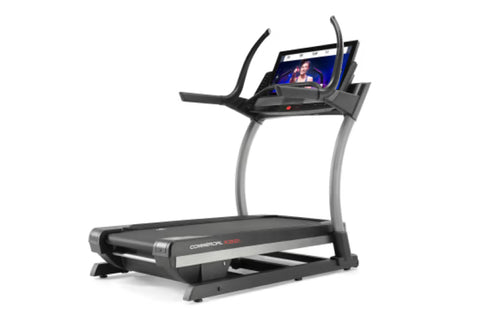 NordicTrack X32i commercial treadmill with black and gray frame, curved handrails, and digital display console on white backg
