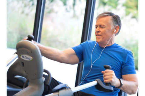 NuStep T5XRW recumbent elliptical stepper with gray frame, blue accents, and black padded seat on white background