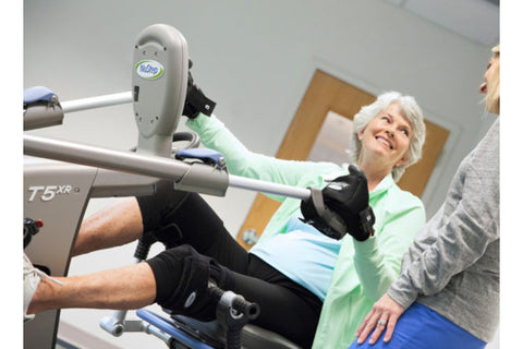 NuStep T5XR recumbent elliptical stepper with gray frame, blue accents, black padded seat, and digital console on white backg