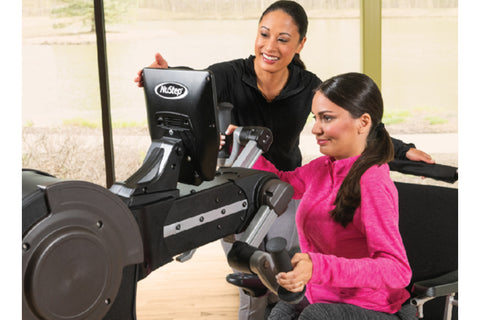 NuStep UE8PRO upper body ergometer with gray and black frame, dual handle bars, footrest, and tablet holder on white backgrou