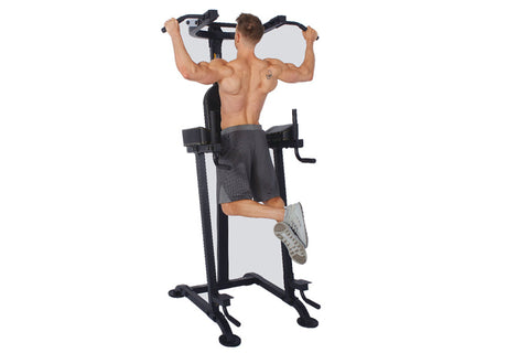 Black vertical power tower with padded seat, drop handles, and leg press footplates on white background