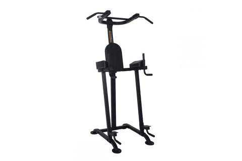 Black vertical power tower with padded seat, drop handles, and leg press footplates on white background