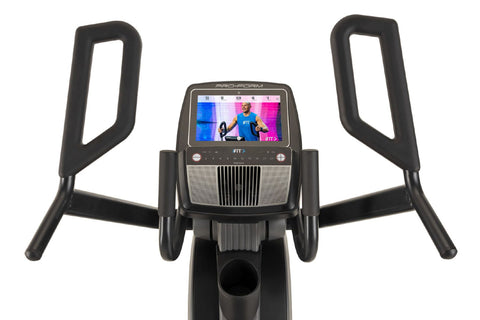 Black and gray upright exercise bike with digital touchscreen display, dual moving handlebars, and textured foot pedals on wh