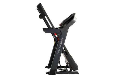Black folding treadmill with digital display console, handrails, and red accent details on white background