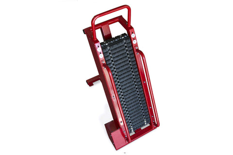 Red metal stair climbing machine with black textured tread surface and dual handles on white background