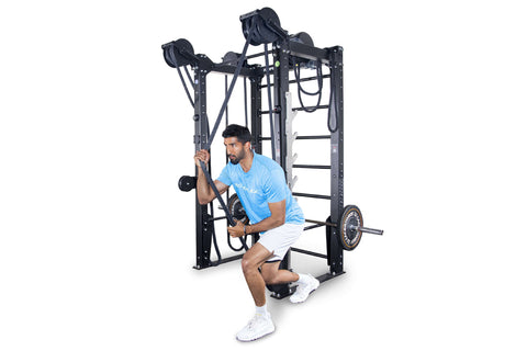 Black cable crossover rope training machine with dual pulleys, adjustable height settings, and ladder-style frame on white ba