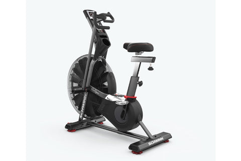 Schwinn Airdyne AD7 stationary exercise bike with black frame, dual-handle grips, padded seat, and large air fan wheel on whi