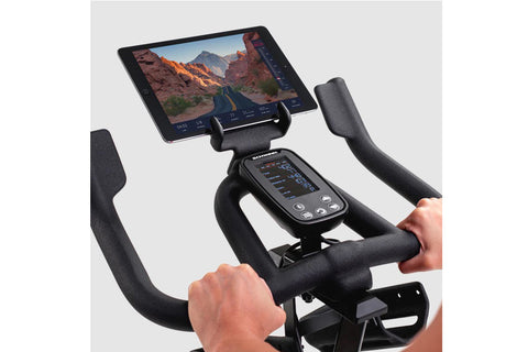 Schwinn IC4 indoor cycling bike with gray frame, red accents, and padded seat on white background