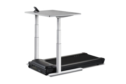Height-adjustable desk treadmill with light wood top, gray steel frame, and black motorized treadmill base on white backgroun