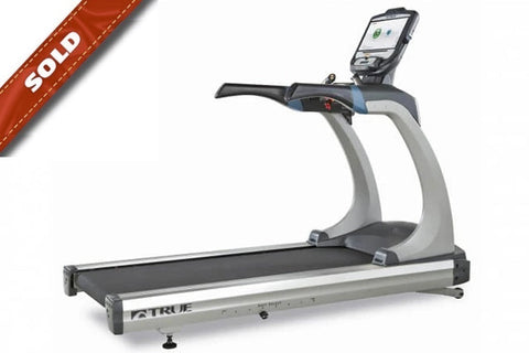 TRUE ES900 commercial treadmill with gray frame, black running belt, digital console, and sold banner overlay