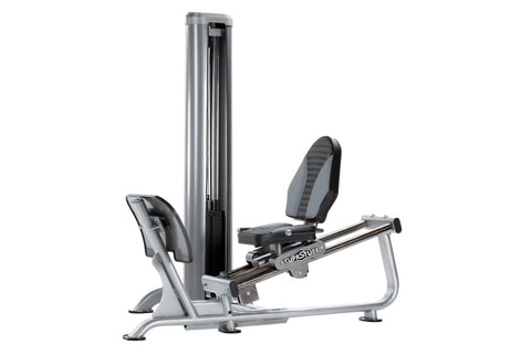 TuffStuff Apollo leg press machine with silver frame, black padded seat and backrest, and vertical weight stack on white back