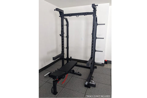 Black multi-function squat rack with adjustable bench, barbell holders, and dumbbell storage pegs on white background