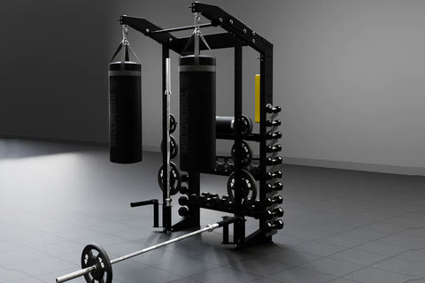 Black steel functional strength station with dual heavy bags, lat pulldown, plate storage, and barbell on gray floor