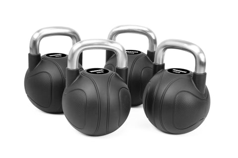 Set of four black rubber kettlebells with chrome handles on white background, fitness equipment for strength training