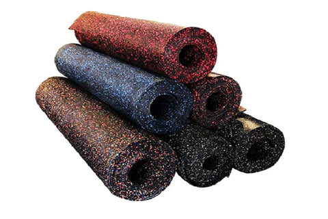 Stacked rubber gym flooring rolls in red, blue, brown, and black speckled colors on white background