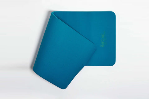 Teal blue exercise mat with rounded corners and textured dual surface on white background