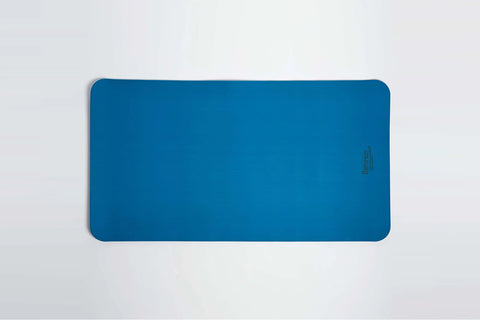 Teal blue exercise mat with rounded corners and textured dual surface on white background