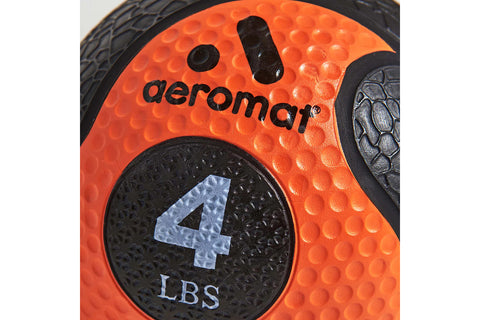 Orange and black rubber medicine ball with textured surface, black braided rope handle and cord attachment on white backgroun