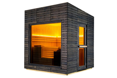 Modern black wooden sauna with orange interior, glass door and window, mounted on wooden deck over mountain lake