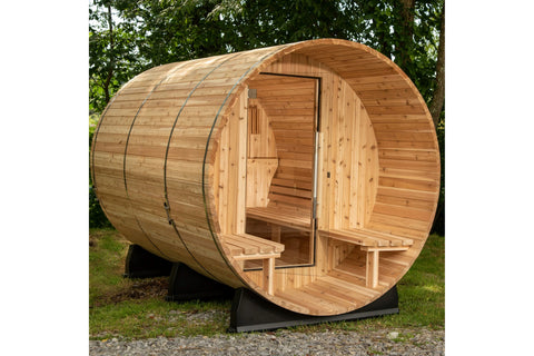 Barrel-shaped wooden sauna with glass door and metal bands, showing interior benches on white background