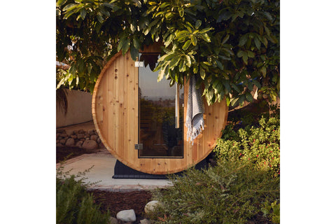 Almost Heaven Essex barrel sauna with natural wood construction, open door showing interior bench seating on white background