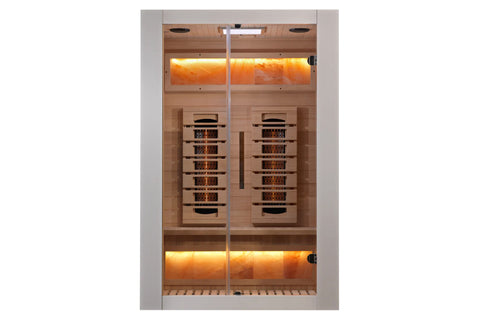 White and light wood infrared sauna with glass doors, cedar interior, warm amber lighting, and infrared heater panels visible