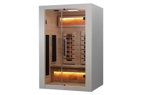 White and light wood infrared sauna with glass doors, cedar interior, warm amber lighting, and infrared heater panels visible