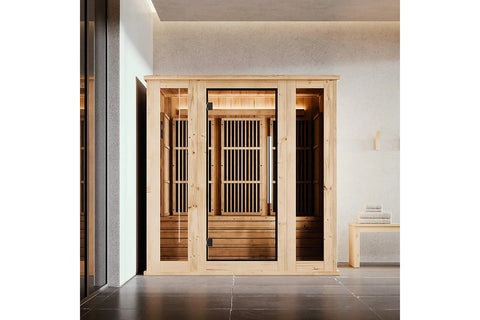 Light wood infrared indoor sauna with black-framed glass door, vertical slat interior panels, wooden benches, and illuminated