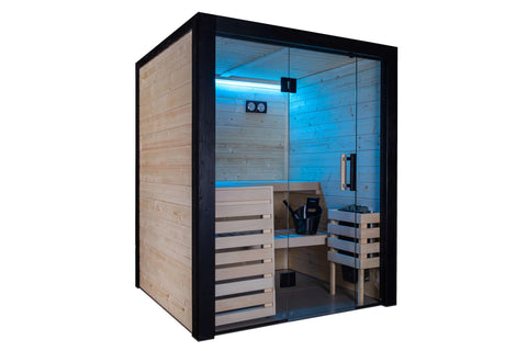 Black framed indoor sauna with glass doors, light wood interior, built-in bench seating, blue LED lighting, and control panel