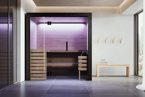 Black framed indoor sauna with glass doors, light wood interior, built-in bench seating, blue LED lighting, and control panel