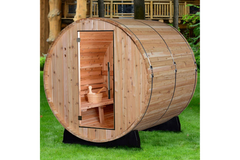 Barrel-shaped wooden sauna with cedar construction, open door revealing interior benches and wooden ladle, mounted on black s
